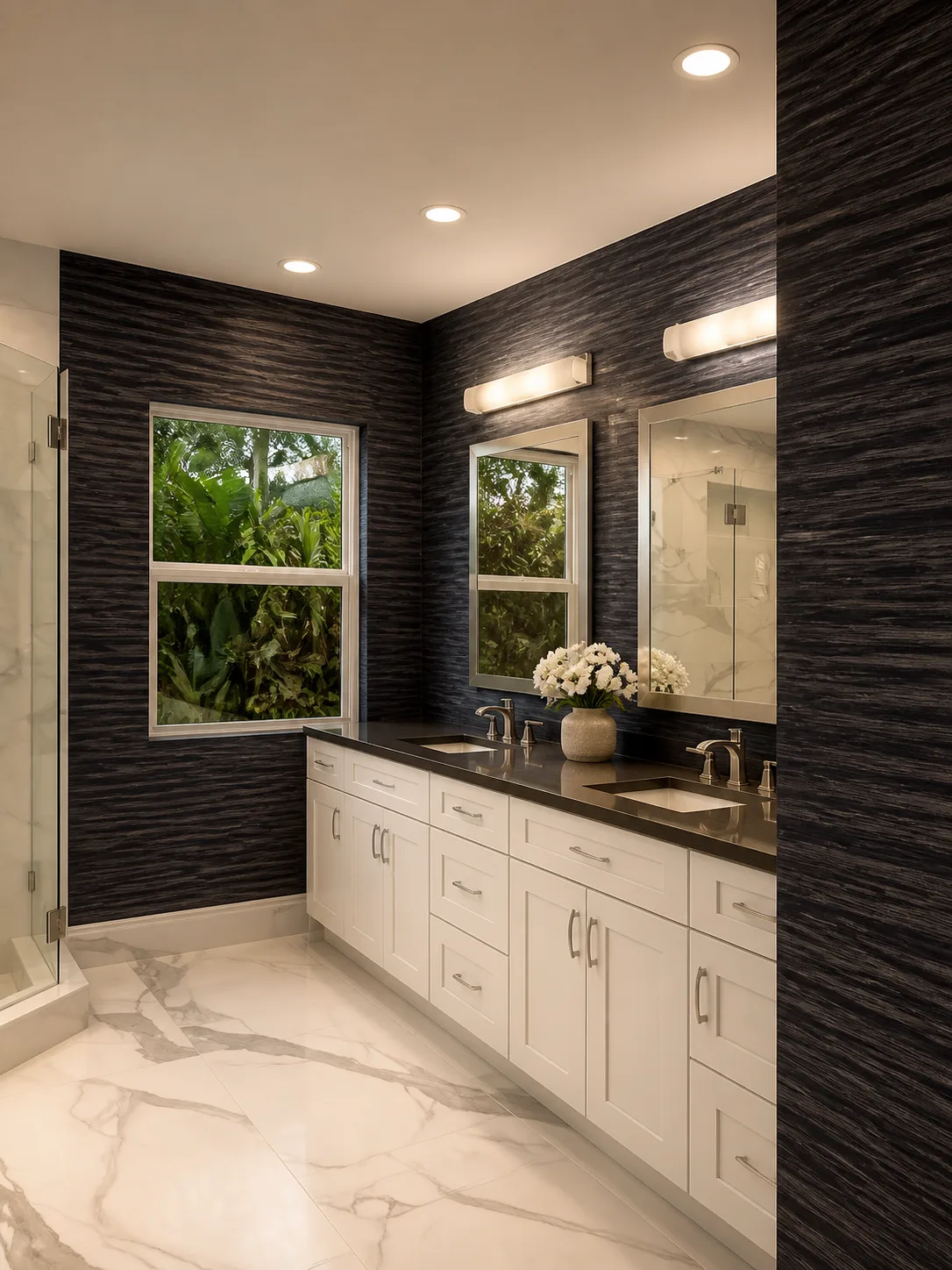 Dark textured wallcovering installed behind a double vanity with black countertops in a primary bathroom