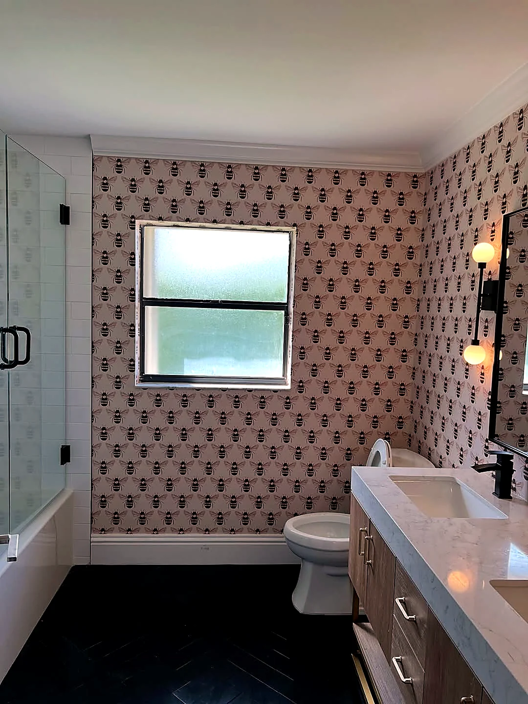 Bee patterned wallpaper installed in a guest bathroom